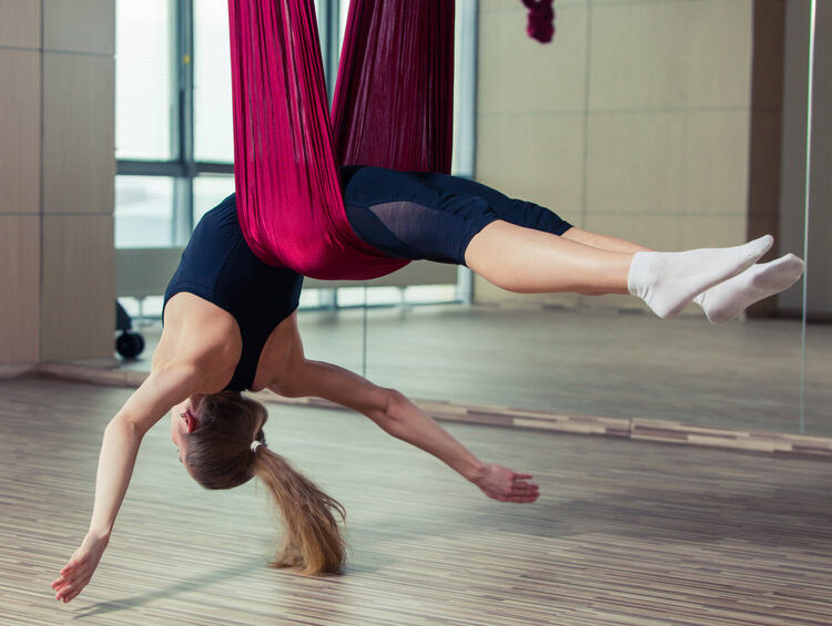 Aerial yoga practicing - anti gravity yoga with scarves
