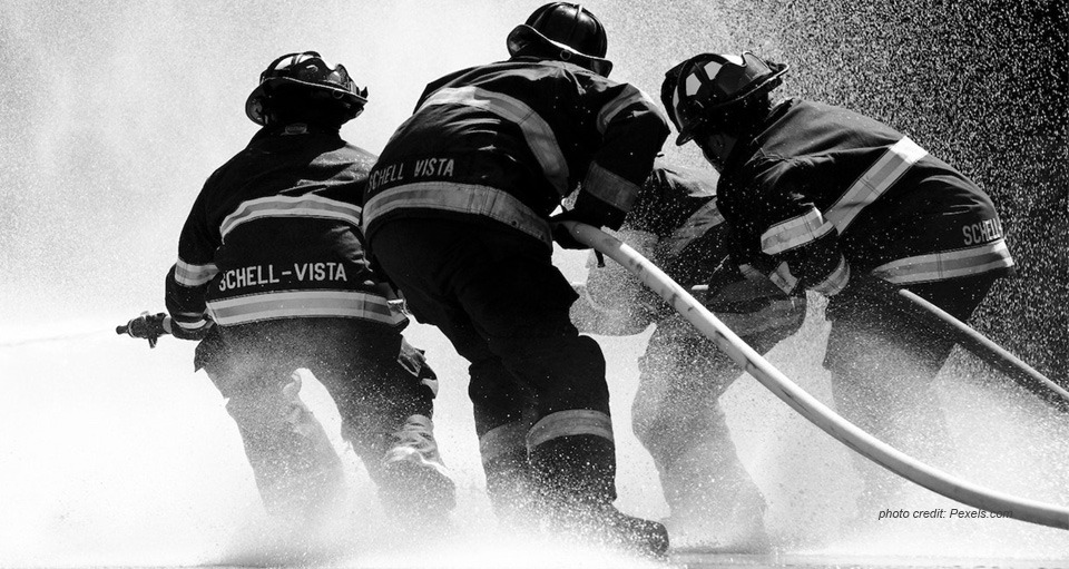 Firefighters in action, black and white photo for Man is an Island in YogaGrit.com, YellWellness.com blog